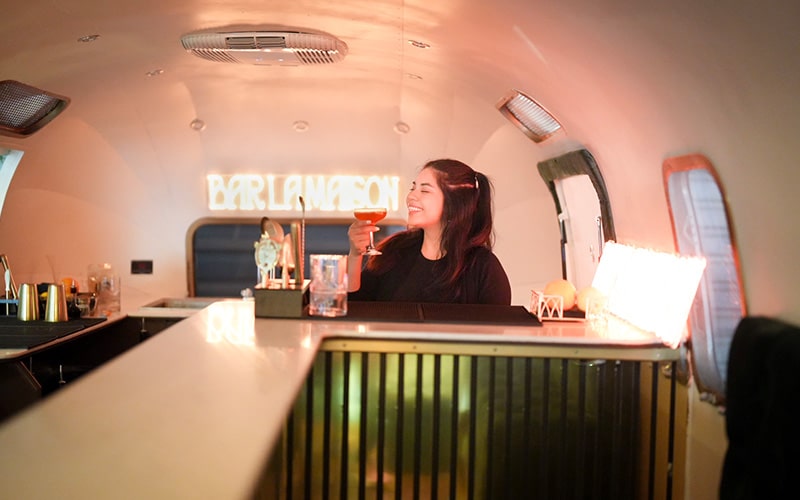 Bartender enjoying a drink inside a mobile luxury bar in austin texas